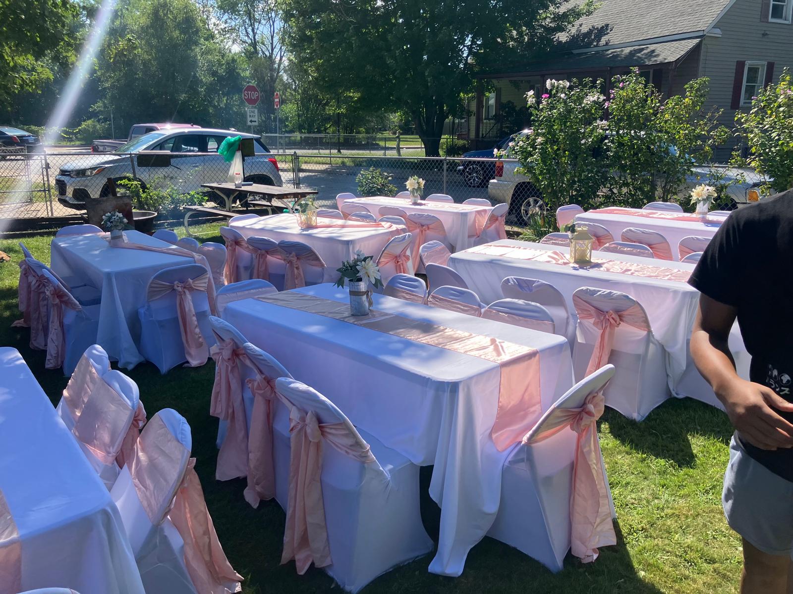 Outdoor wedding with pink sashes